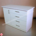 White dresser with four drawers on a beige background
