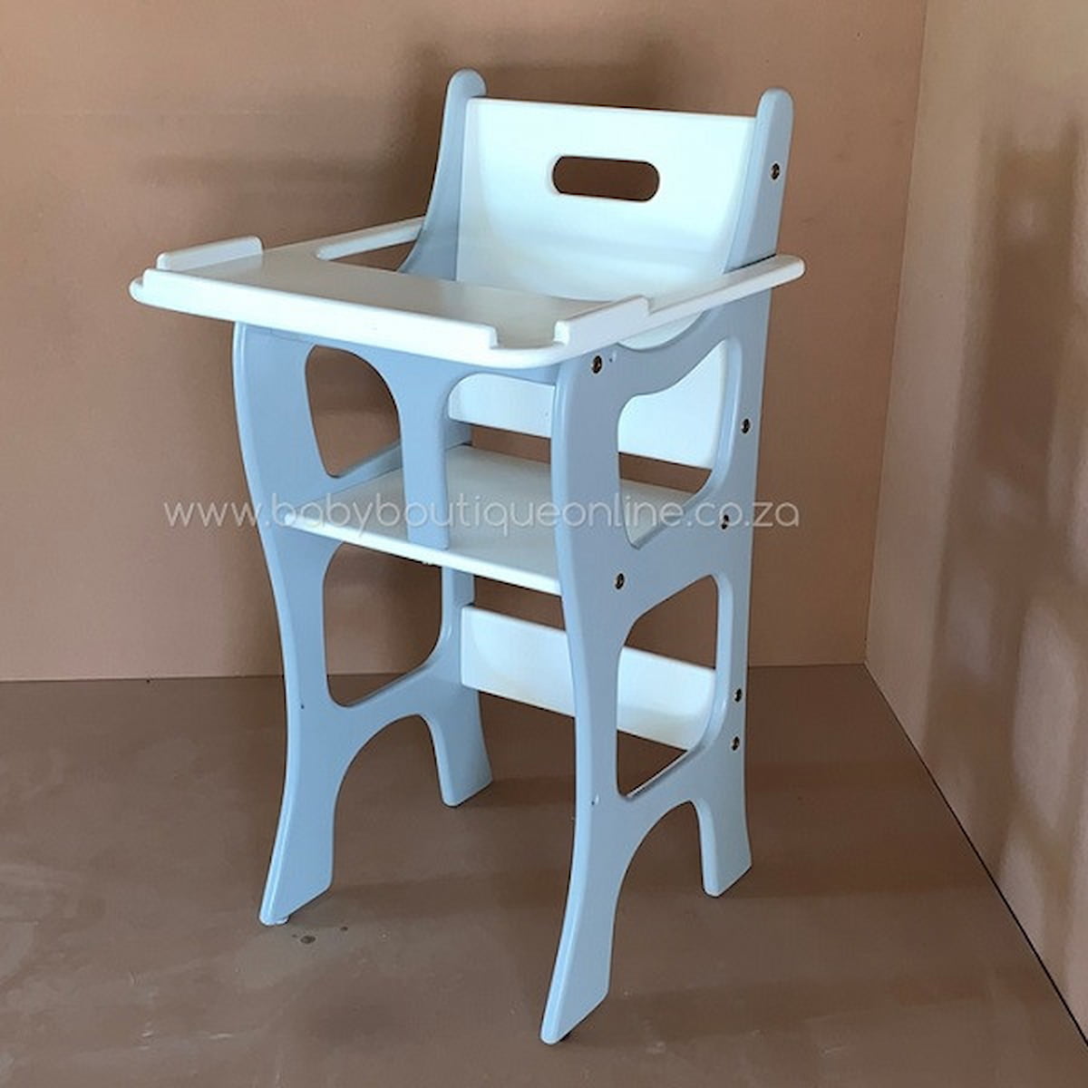 White baby high chair against a plain background