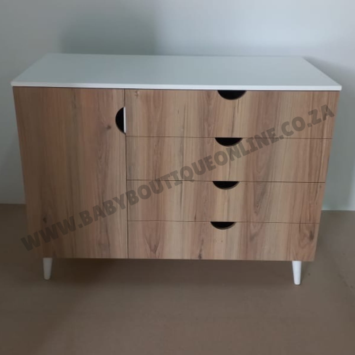 Wooden dresser with white top on a plain background