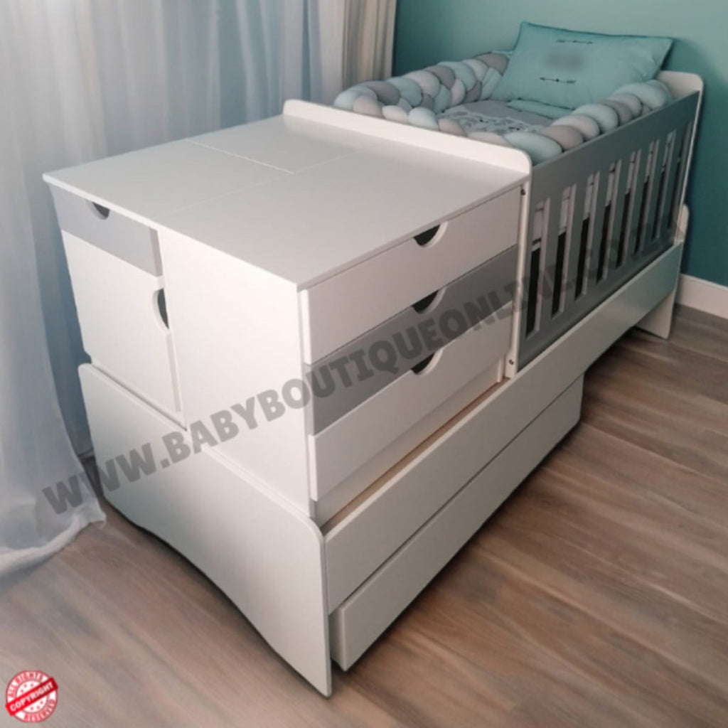 BabyBedroominabox-5in1 White crib with drawers in a room setting, featuring a visible brand watermark.