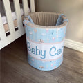 Baby care bin with cartoon designs and 'Baby Care' text in a nursery setting.